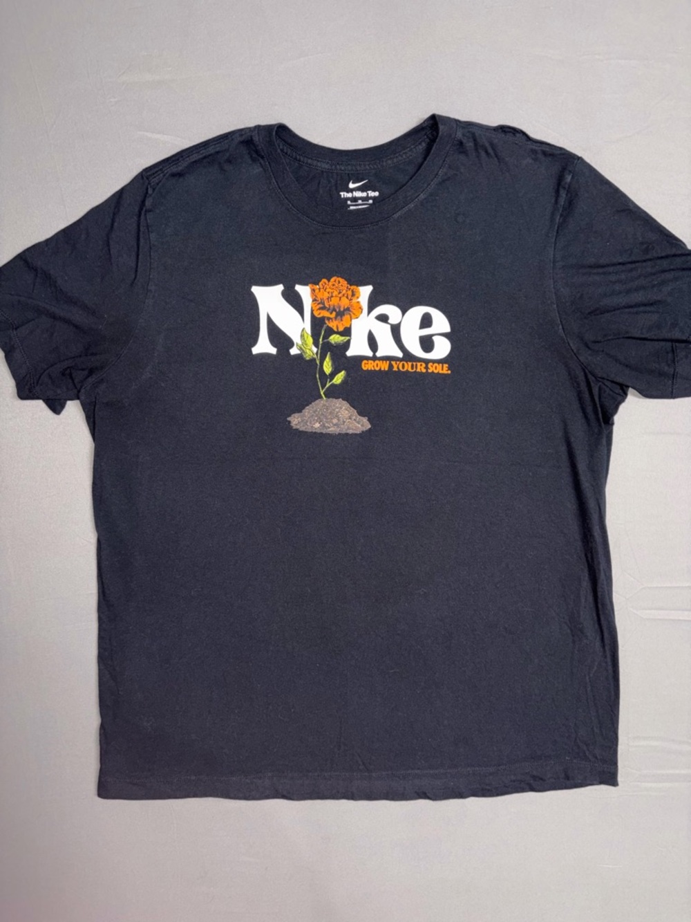 Nike Black Graphic Tee with Orange Floral Logo